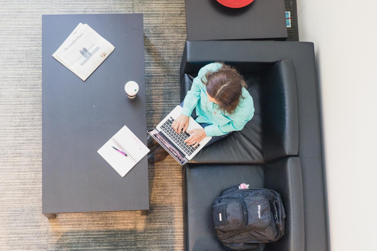 View of woman working on a laptop from above