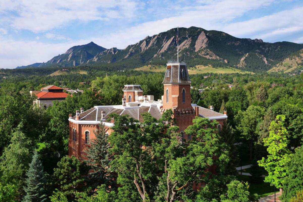 Old Main building and flatirons in the background 