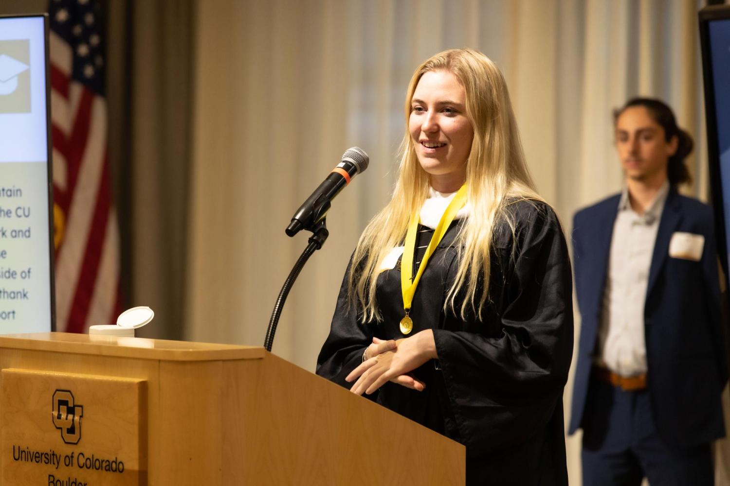 Female MSOL graduate at a podium