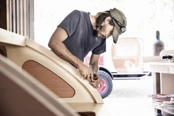 man working on building a custom camper