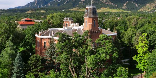 Old Main building and flatirons in the background 