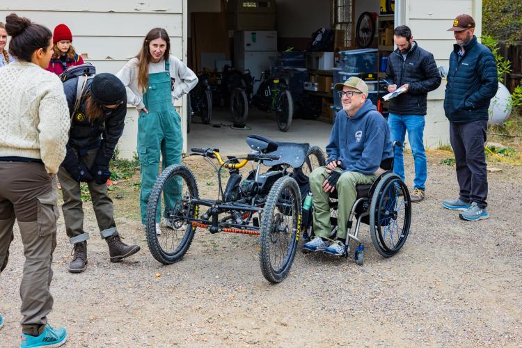 Outdoor Rec students looking at an adaptive bike.