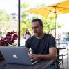 Man working on a laptop at a cafe