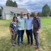 Natalie Ooi, Mark Gasta, Joel Hartter and unnamed man standing in front of a barn